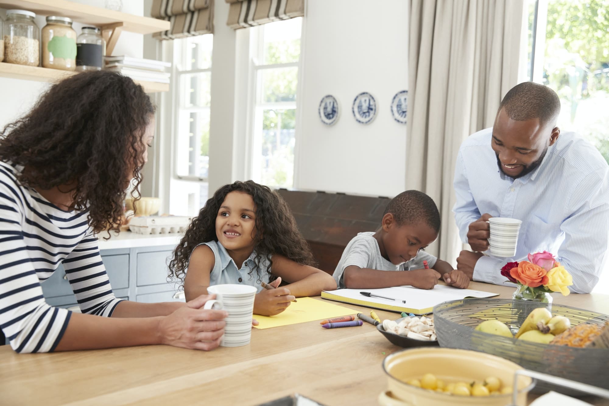 Young black family together in their kitchen, close up