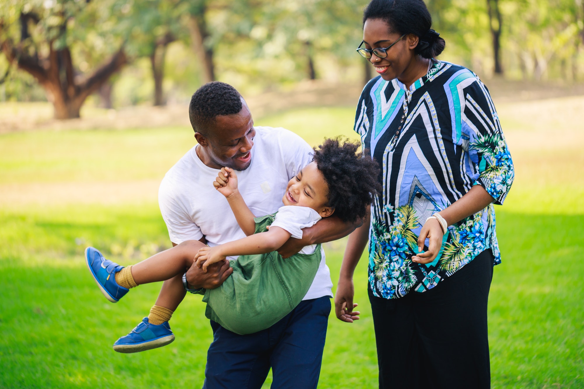 Happy African American Parents and son enjoy in the park
