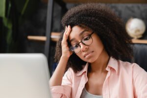 Failed test,exam, debt, sad news. Overworked african girl student woman freelancer having headache
